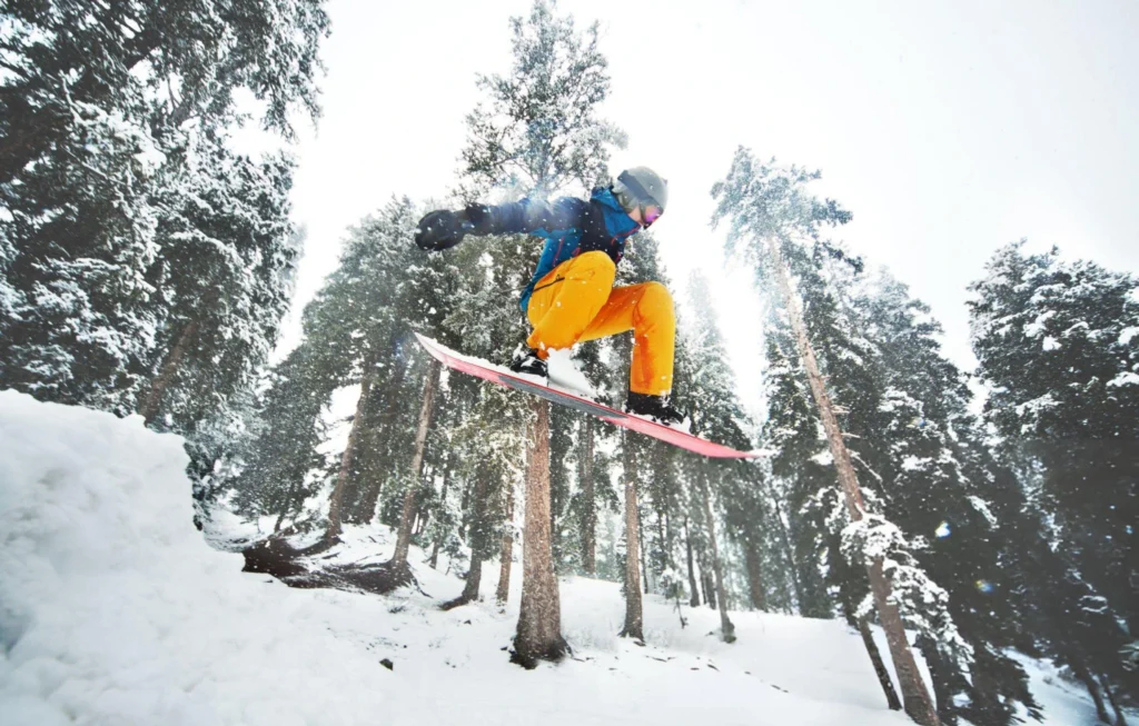 now-covered mountains in Gulmarg, with visitors enjoying skiing and the Gulmarg Gondola.