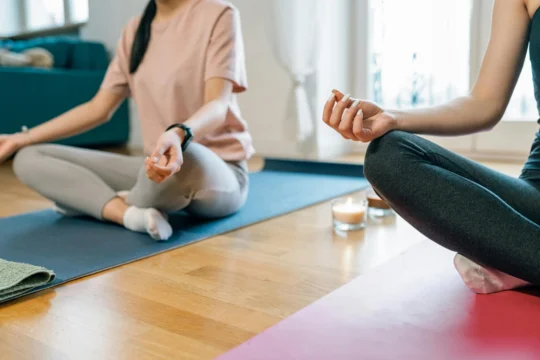A person practicing yoga in a serene winter setting, promoting health and mindfulness.